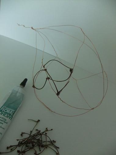Glue the cherry twigs on to the frame Glue the cherry twigs on to the frame