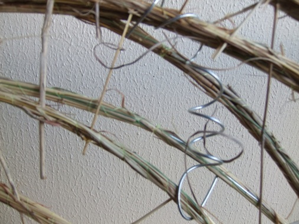 Add wire coils to mimic the natural coils of the dried grass and add a shiny contrast to the dull grass.
