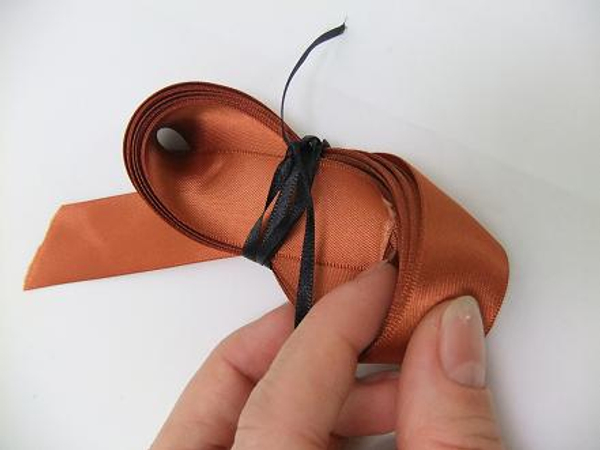 Tie the infinity fold lightly with a thin ribbon