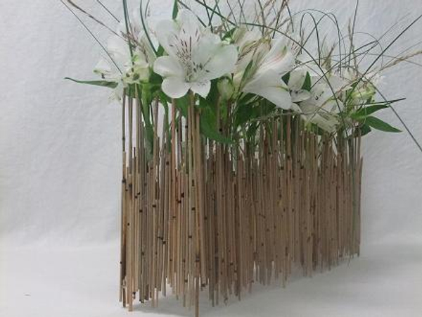 Alstroemeria and grass in a Mikado reed armature.