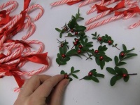 Dress up candy cane favors with boxwood, ribbon and beads