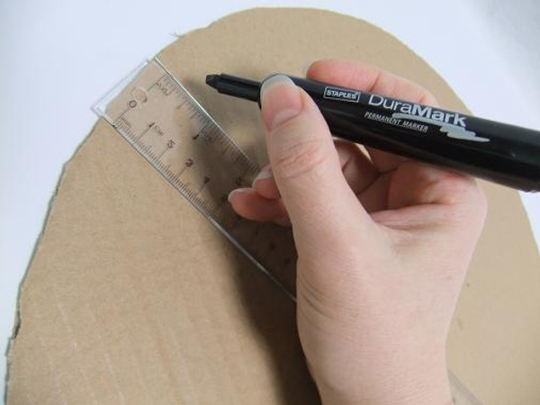 Draw a line about a ruler width right through the middle of the cardboard circle