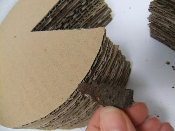 Glue chips of bark to the cardboard stack