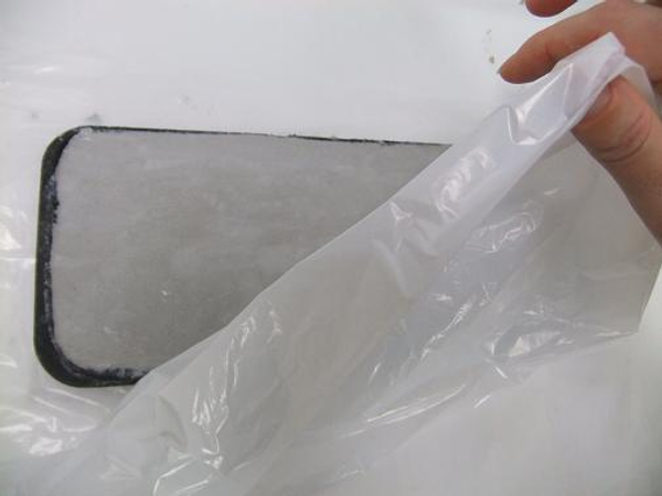 Cover the cement tray with plastic and set aside to let the water soak in.