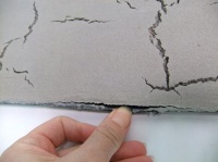 Casting wet cement to have surface cracks