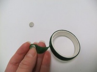 Covering corsage magnets with florist tape