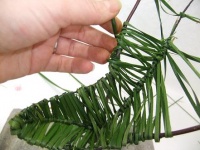 Weaving a pod shape from ripped foliage