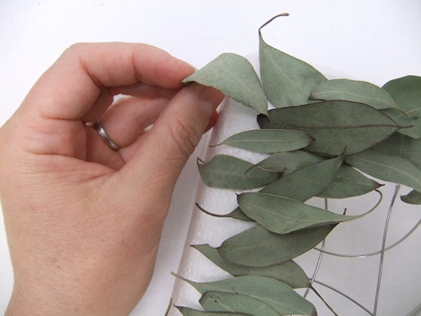 Decorate polystyrene by gluing or pinning plant material to it.