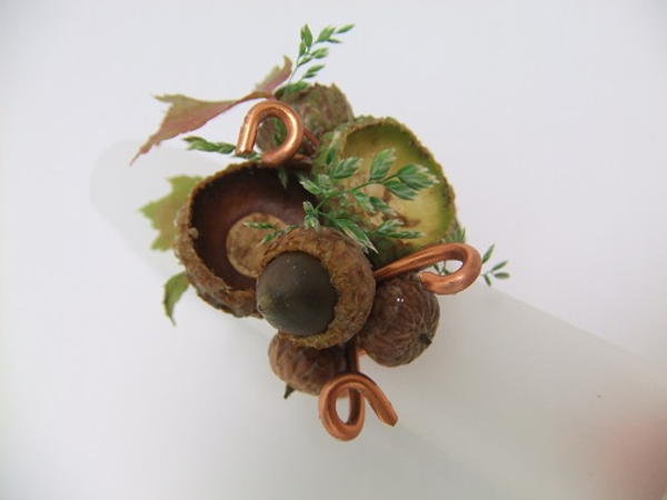 Autumn ring design with copper wire, acorns, grass and fall leaves
