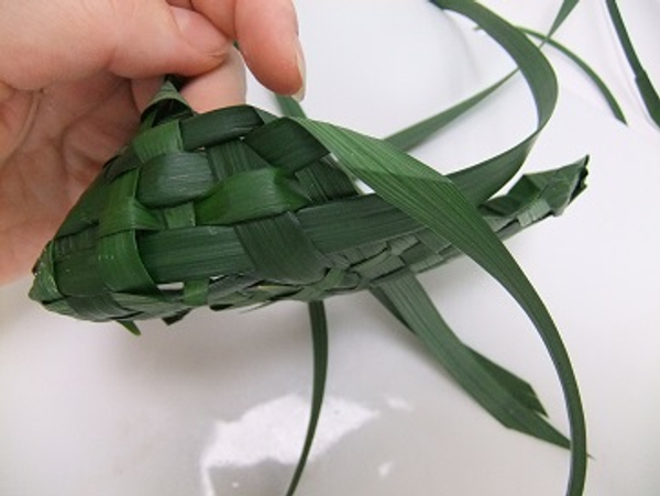Simply fold over the leaf and weave it