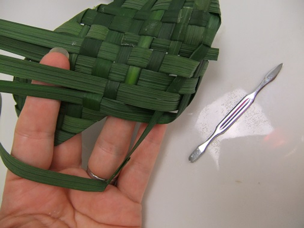 To make it easier to feed the leaves back into the weave use a cuticle pusher as a guide