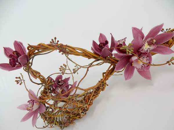 Cymbidium orchids, eucalyptus capsules woven into a willow wand
