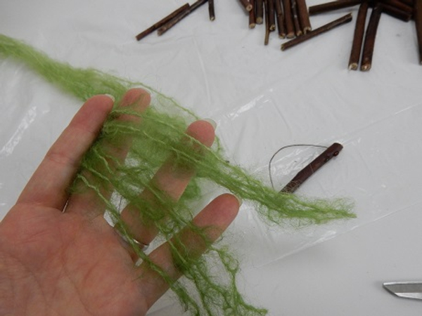 Cut four long strands of wool