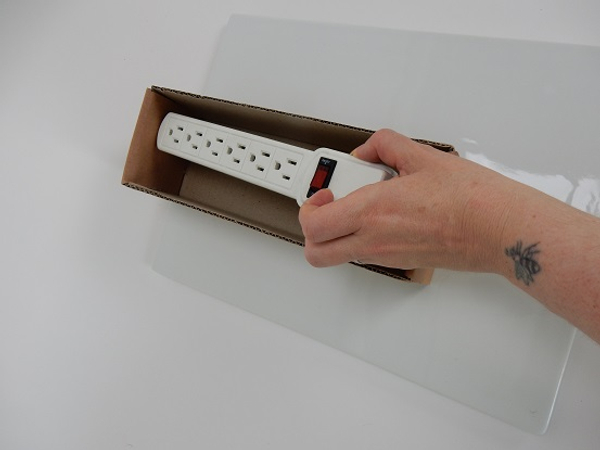 Measure the box by placing the power strip into the box.