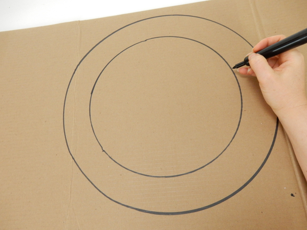 Draw two circles on a sturdy cardboard sheet.