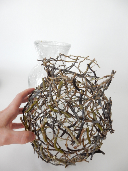 Lift the twig shape away from the vase.