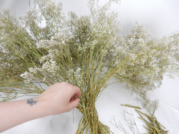 Cut the tiny flowers away from a huge bunch of dried Baby's breath