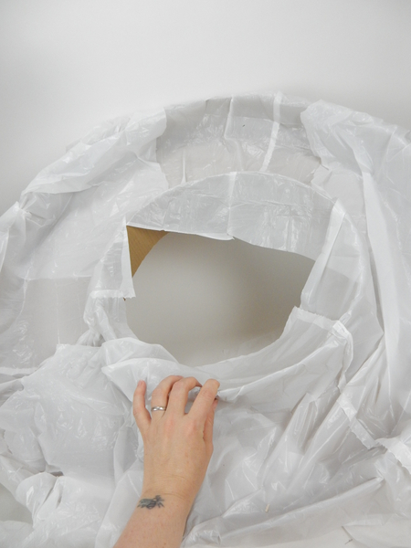 Line the cardboard wreath shape with a thin layer of plastic