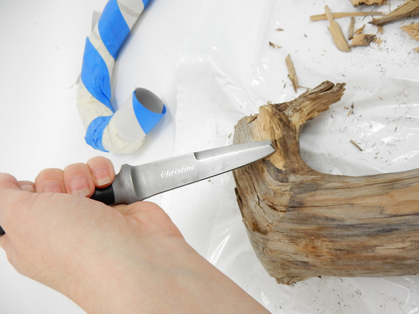 Chip away some bark with a sharp knife from a piece of wood