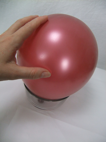 Set the balloon on a small bowl so that it doesn't roll around while you work
