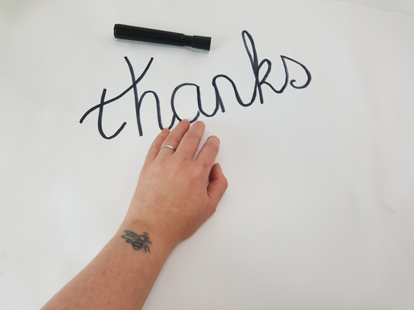 Write your message on a flat working surface with a marker.