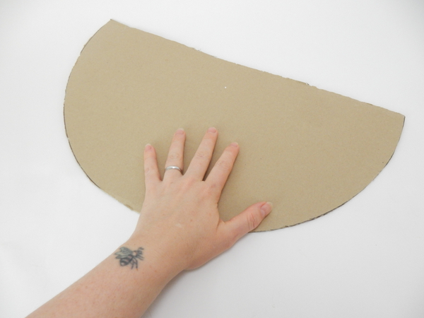 Cut a large cardboard circle to almost half.