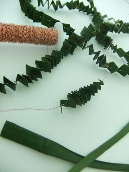 Folding a pleated garland out of foliage Folding a pleated garland out of foliage