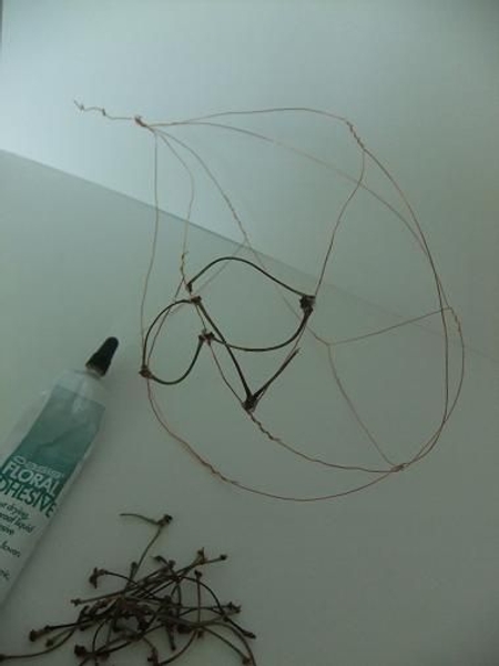 Glue the cherry twigs on to the frame Glue the cherry twigs on to the frame