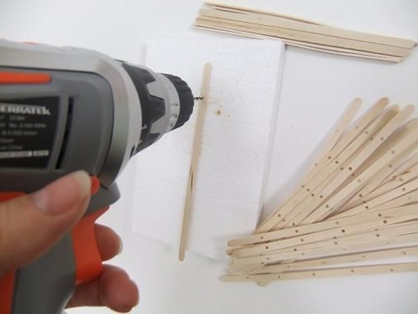 Making the fan- drill holes in the coffee stir sticks