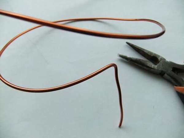Bending a copper wire spiral cage for floral art Bending a copper wire spiral cage for floral art
