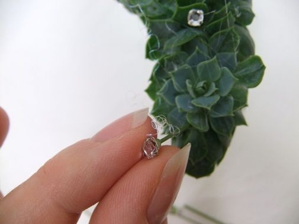 Add a few sparkling beads to secure the angel hair Add a few sparkling beads to secure the angel hair