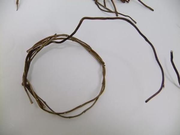 Add another twig by hooking it into the wreath Add another twig by hooking it into the wreath