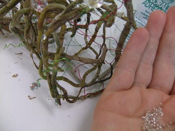 Glue in tiny ice pellet beads to add sparkle on the orchid roots. Glue in tiny ice pellet beads to add sparkle on the orchid roots.