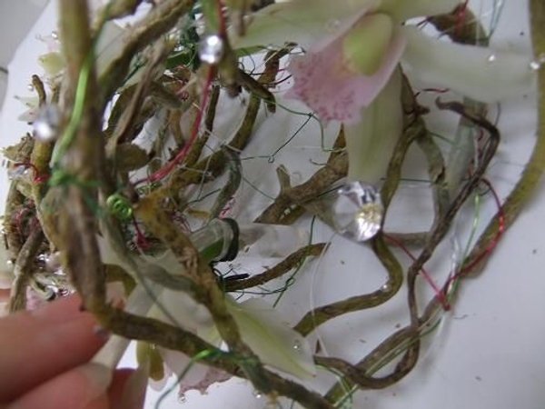 Wire in a few small test tubes to keep the orchids fresh Wire in a few small test tubes to keep the orchids fresh