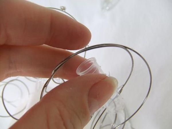 Add the tiny test tubes into the wire spiral network and fill with water before inserting the flowers Add the tiny test tubes into the wire spiral network and fill with water before inserting the flowers