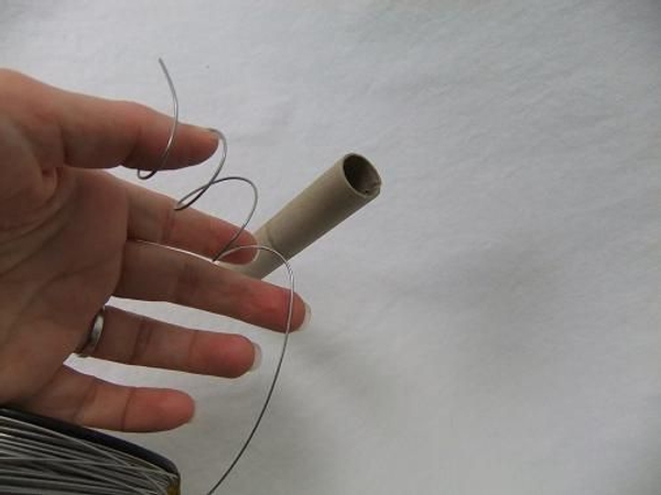Curl the wire into a spiral by wrapping it tightly around a paper tube Curl the wire into a spiral by wrapping it tightly around a paper tube