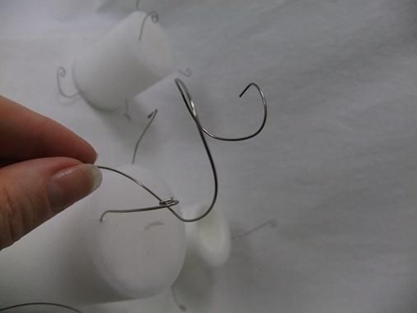 Feed the wire spiral into the candle wires Feed the wire spiral into the candle wires