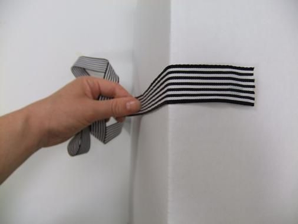 Let the ribbon drape naturally down the door Let the ribbon drape naturally down the door