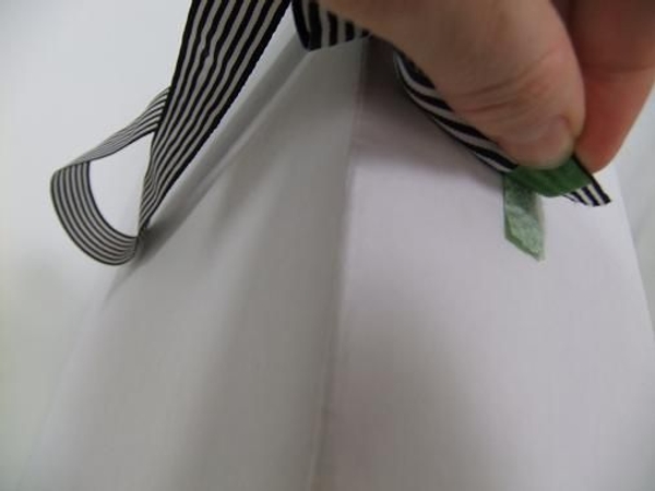 Place the two velcro pieces together making sure the ribbon hangs straight Place the two velcro pieces together making sure the ribbon hangs straight
