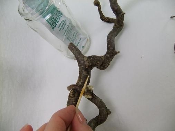 Start to glue the twig filigree twig wreath by making a frame with the larger twigs Start to glue the twig filigree twig wreath by making a frame with the larger twigs