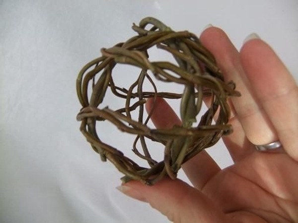 Continue to build up the ball shape by placing the wreaths over the first two willow wreaths Continue to build up the ball shape by placing the wreaths over the first two willow wreaths