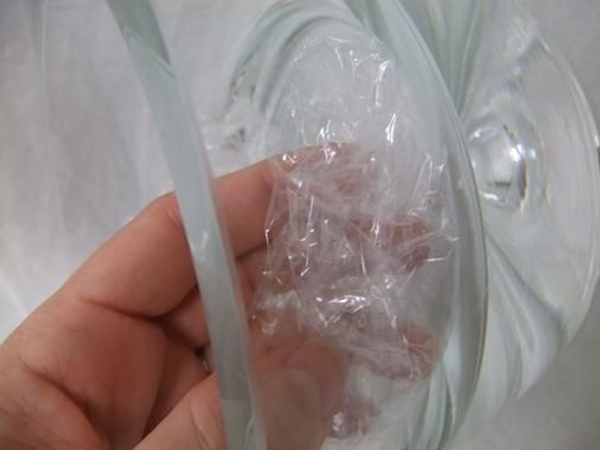 Crumple cellophane or cling wrap and place in a glass container Crumple cellophane or cling wrap and place in a glass container