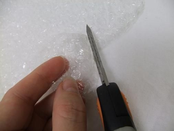 Cut a disk out of the bubble wrap to make a flower float raft Cut a disk out of the bubble wrap to make a flower float raft