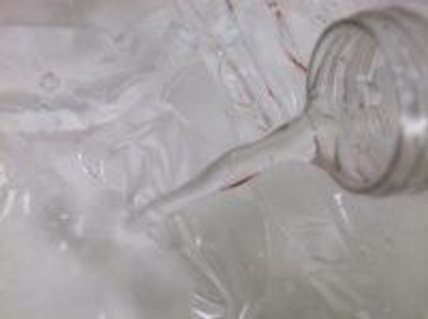 Fill the glass container with water over the cellophane to create the appearance of cracked ice Fill the glass container with water over the cellophane to create the appearance of cracked ice