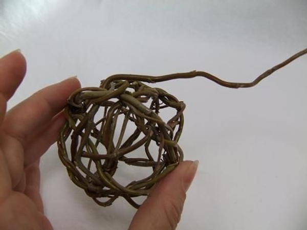 To break up the wreath lines I now weave in long stems of thin willow To break up the wreath lines I now weave in long stems of thin willow