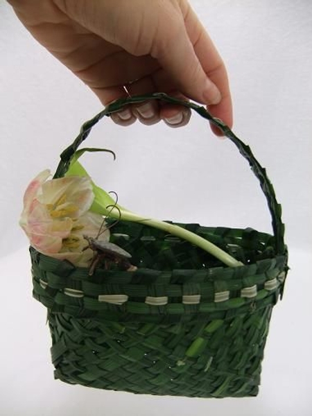 A hand basket woven from green grass A hand basket woven from green grass