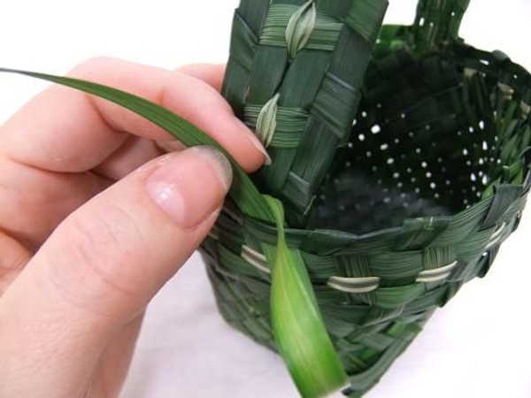 Stitch the second strand to create a handle. Stitch the second strand to create a handle.