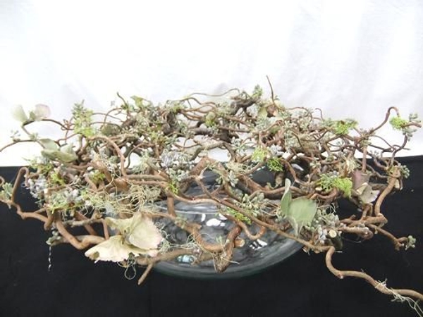 Forest filigree twig wreath set on a glass vase. Forest filigree twig wreath set on a glass vase.