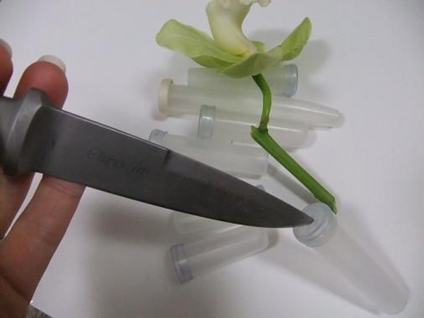 If it is a tight fit cut a small slit in the plastic lid. If it is a tight fit cut a small slit in the plastic lid.