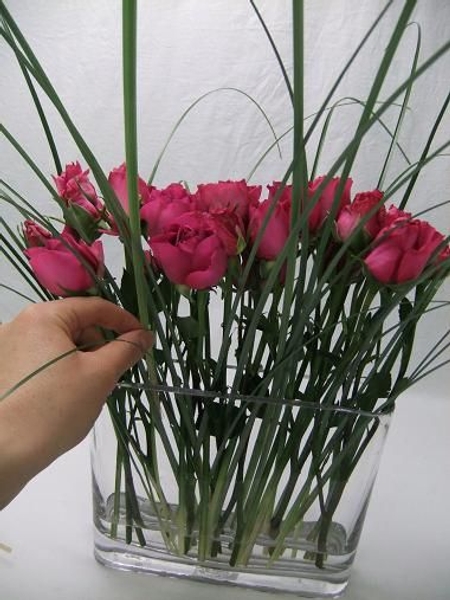 Add blades of grass into the vase. Add blades of grass into the vase.